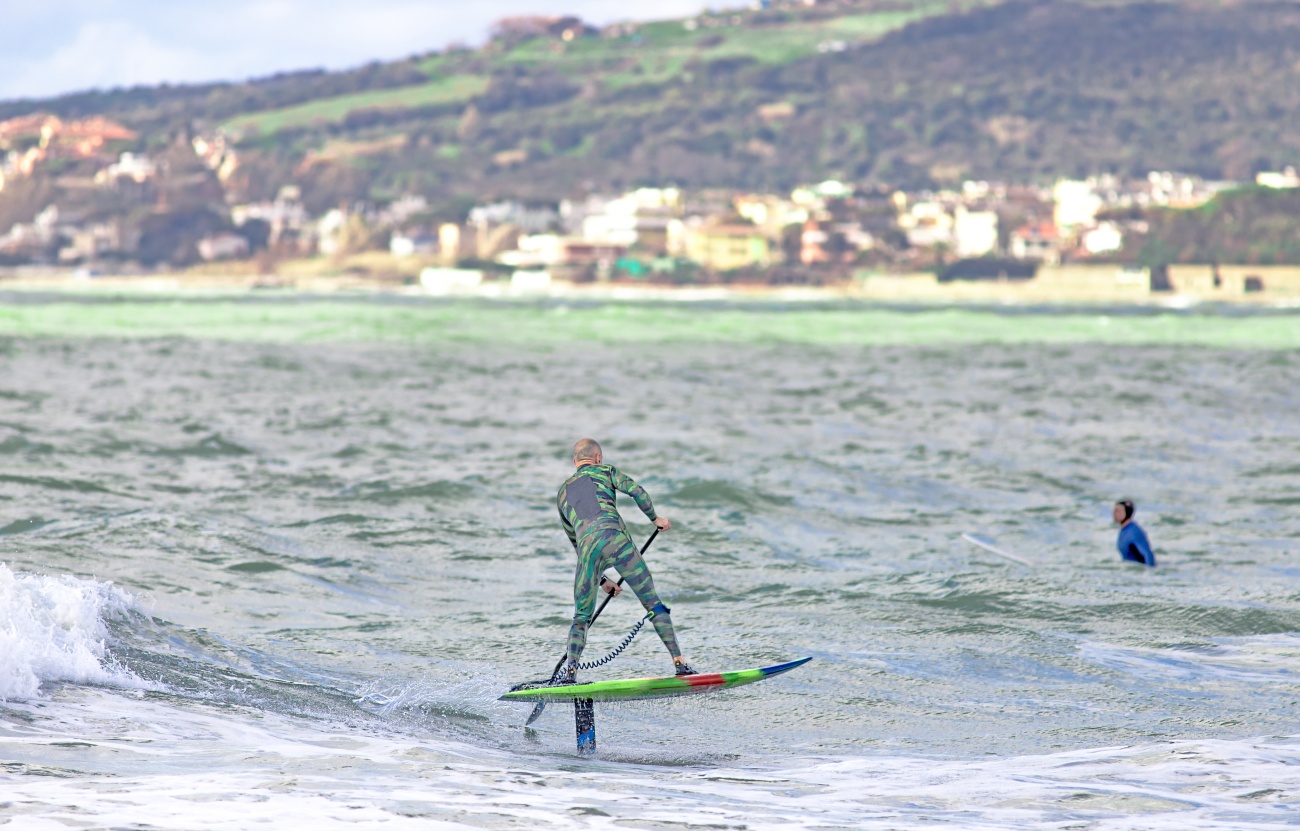 Stand-up paddler on a foil board