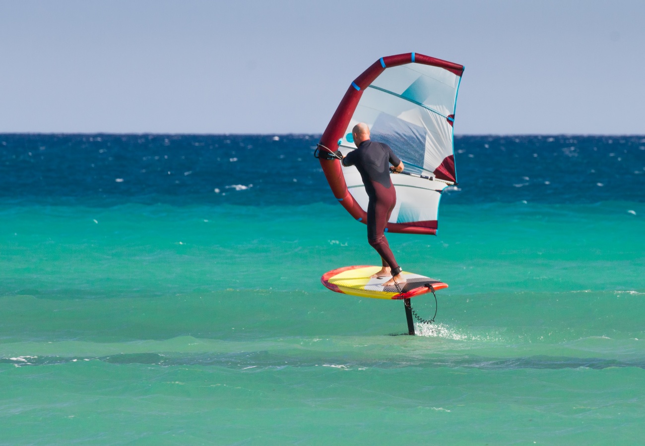 Wingfoil rider holding an inflatable wing